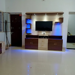 Bespoke LED-integrated TV media center with two-tone laminate shelving — interior design Dindigul